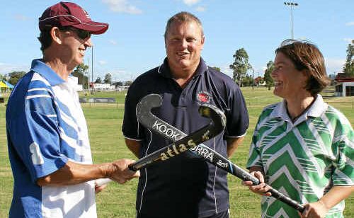 Sevens tournament co-ordinator Jim Rolfe (centre) prepares Steve Farrell (left) and Michelle Eastwell for battle on the hockey field this weekend.